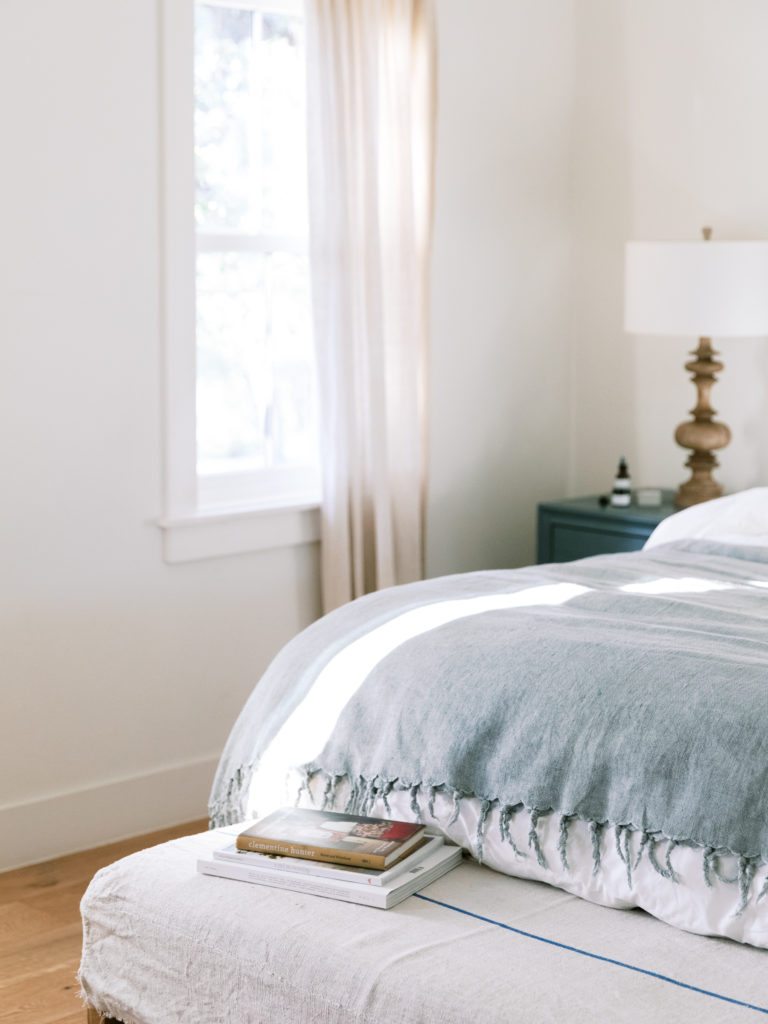 Light and Airy Small Bedroom with a King Bed Decorated with White painted walls and Natural Light Pouring In