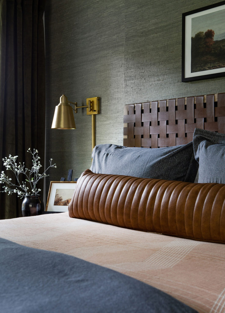 Dark and Moody Small Bedroom with a Kind Sized Bed Decorated with a Woven Leather Headboard